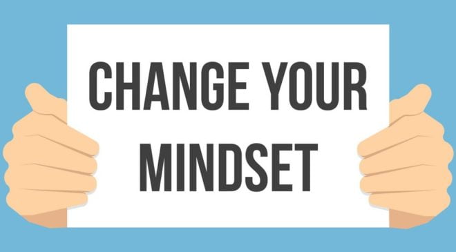 man-showing-paper-change-your-MINDSET